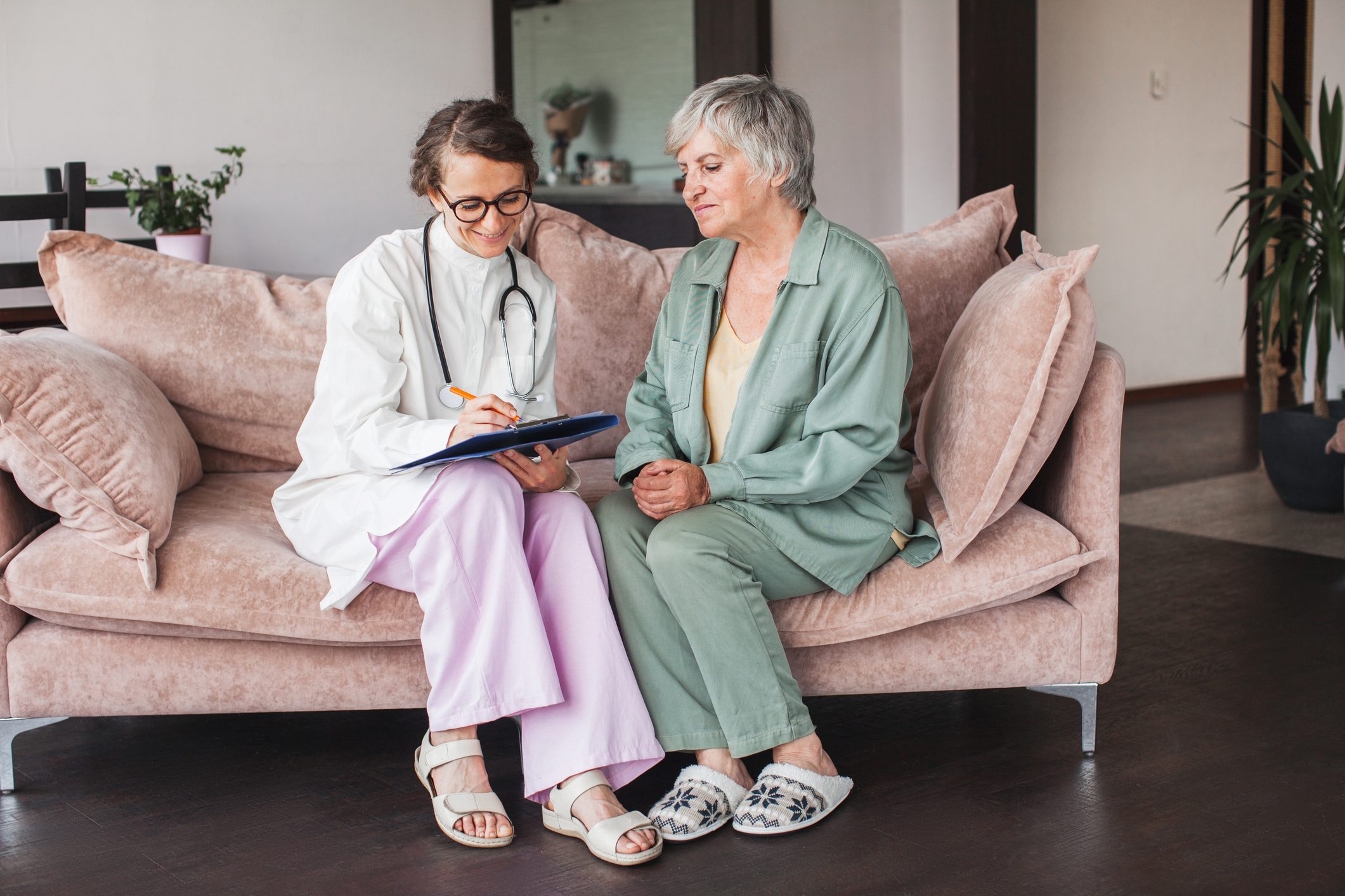 Doctor and patient talking on a couch.